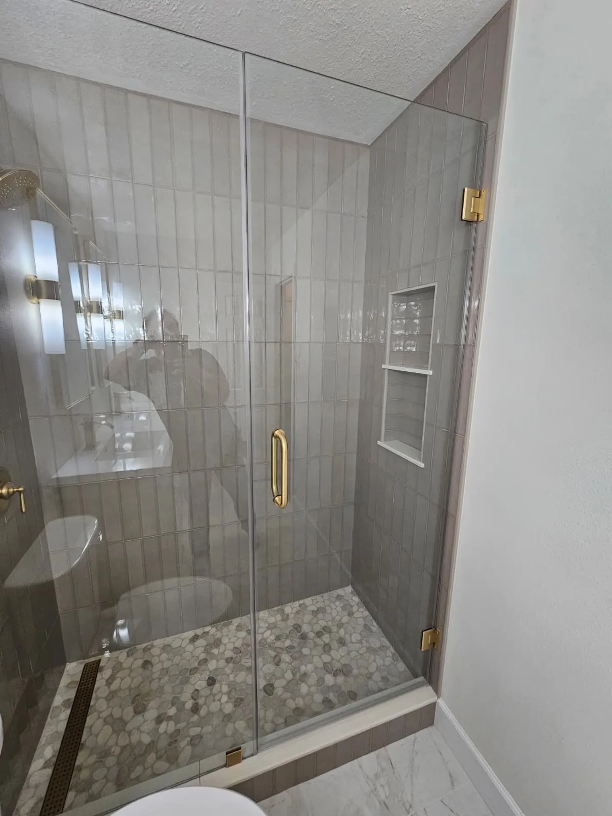 Bathroom remodel with a walnut double vanity and brushed gold fittings in Alden Bridge, The Woodlands, TX