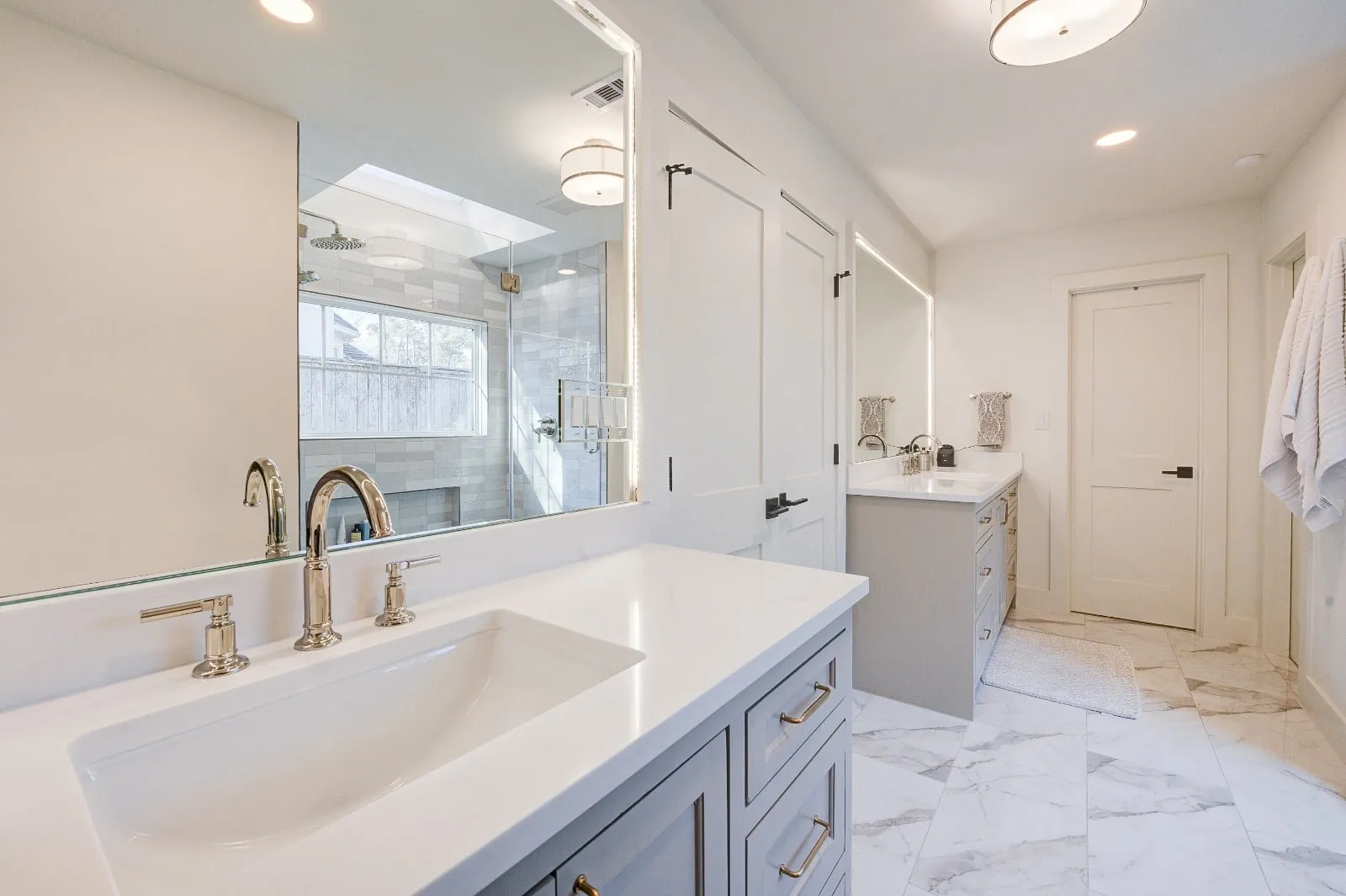 Marble bathroom with frameless glass and brushed nickel fittings in Carlton Woods, The Woodlands, TX