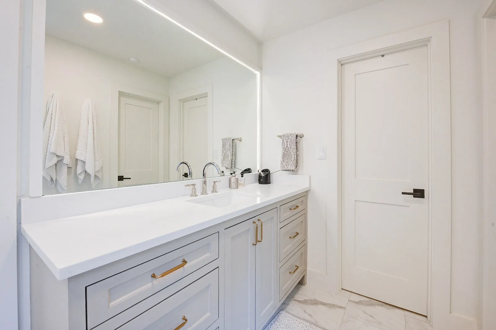 Marble bathroom with frameless glass and brushed nickel fittings in Carlton Woods, The Woodlands, TX