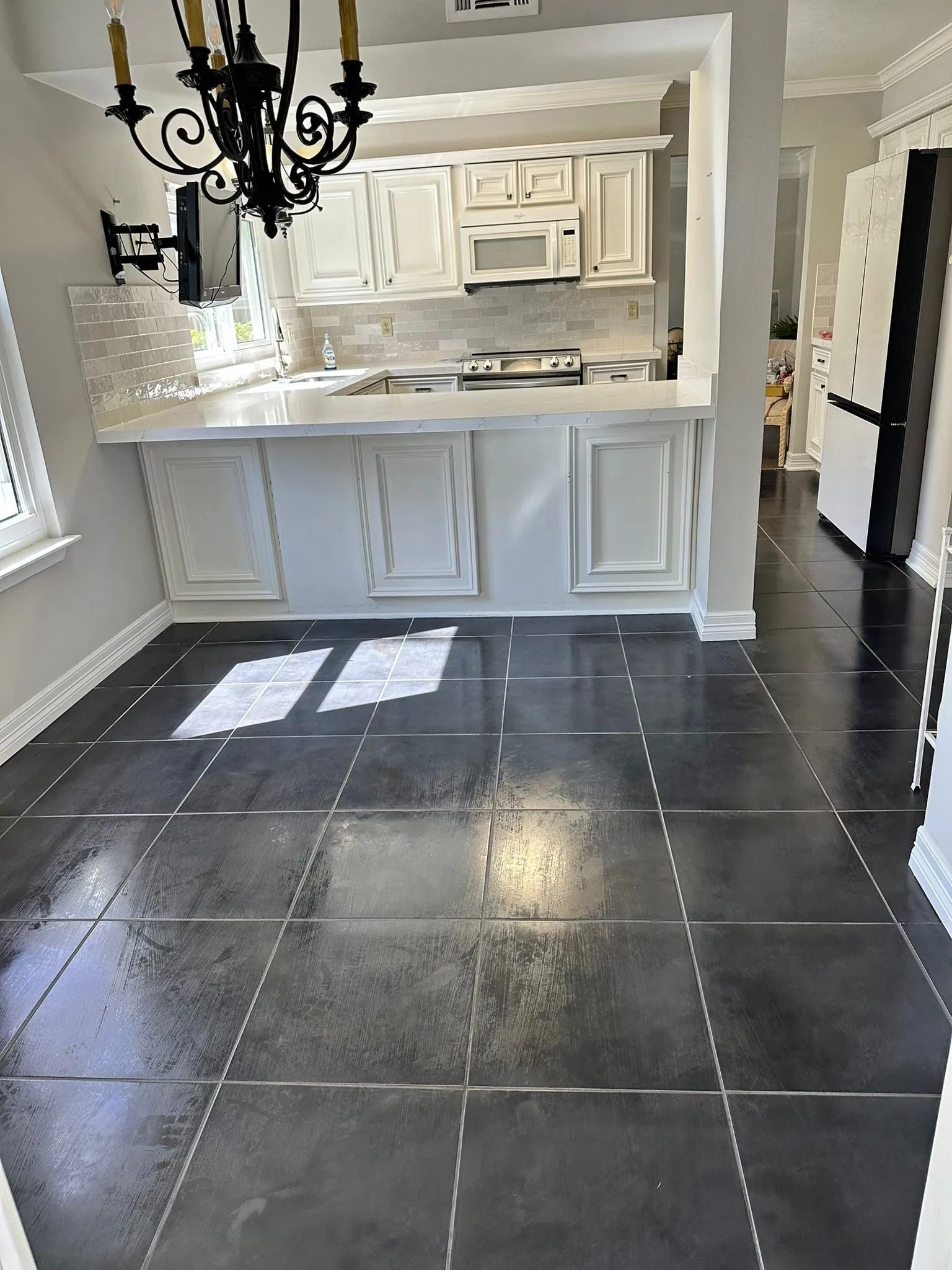 Ivory raised-panel kitchen with quartz counters and a stone backsplash in Cochran’s Crossing, The Woodlands, TX