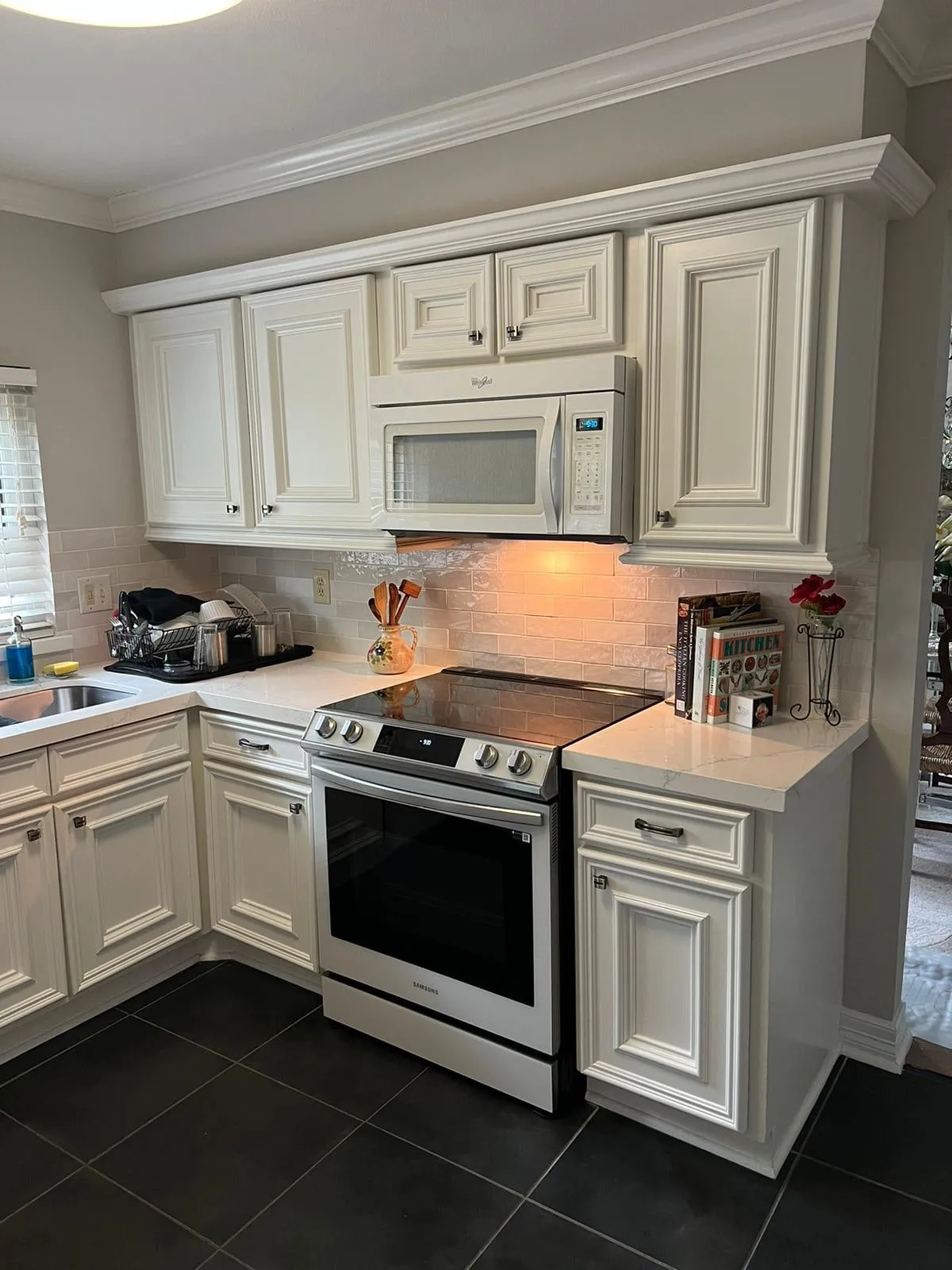 Ivory raised-panel kitchen with quartz counters and a stone backsplash in Cochran’s Crossing, The Woodlands, TX