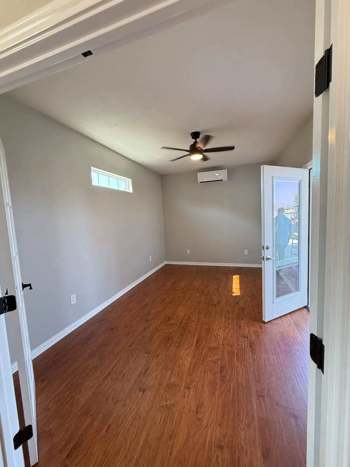Home addition opening to the existing house through French doors in Creekside Park, The Woodlands, TX