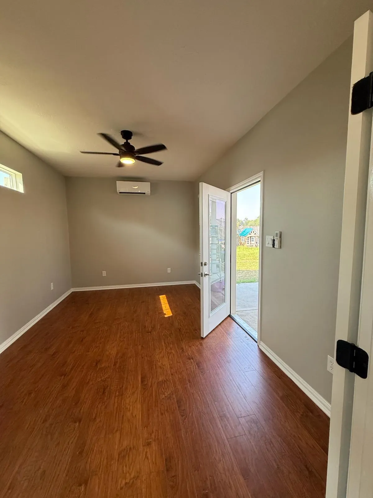 Home addition opening to the existing house through French doors in Creekside Park, The Woodlands, TX