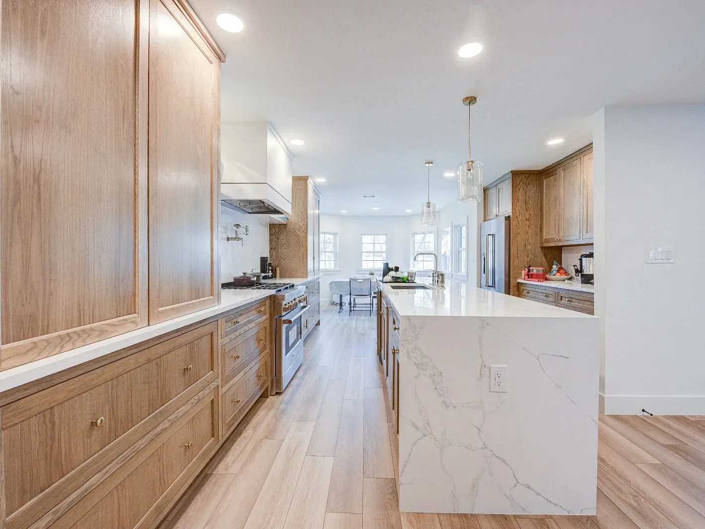 Long run of custom oak cabinetry and millwork in a kitchen remodel in The Woodlands, TX