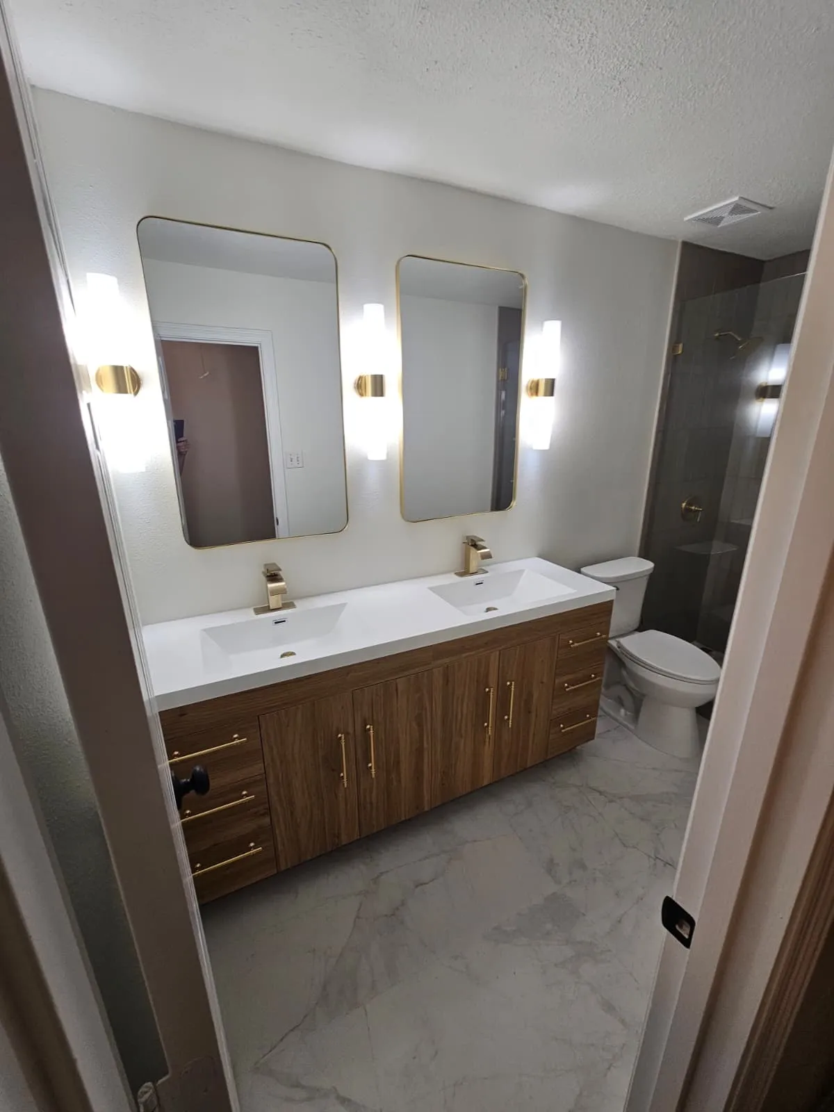 Double vanity bathroom remodel with brushed gold fittings in The Woodlands, TX