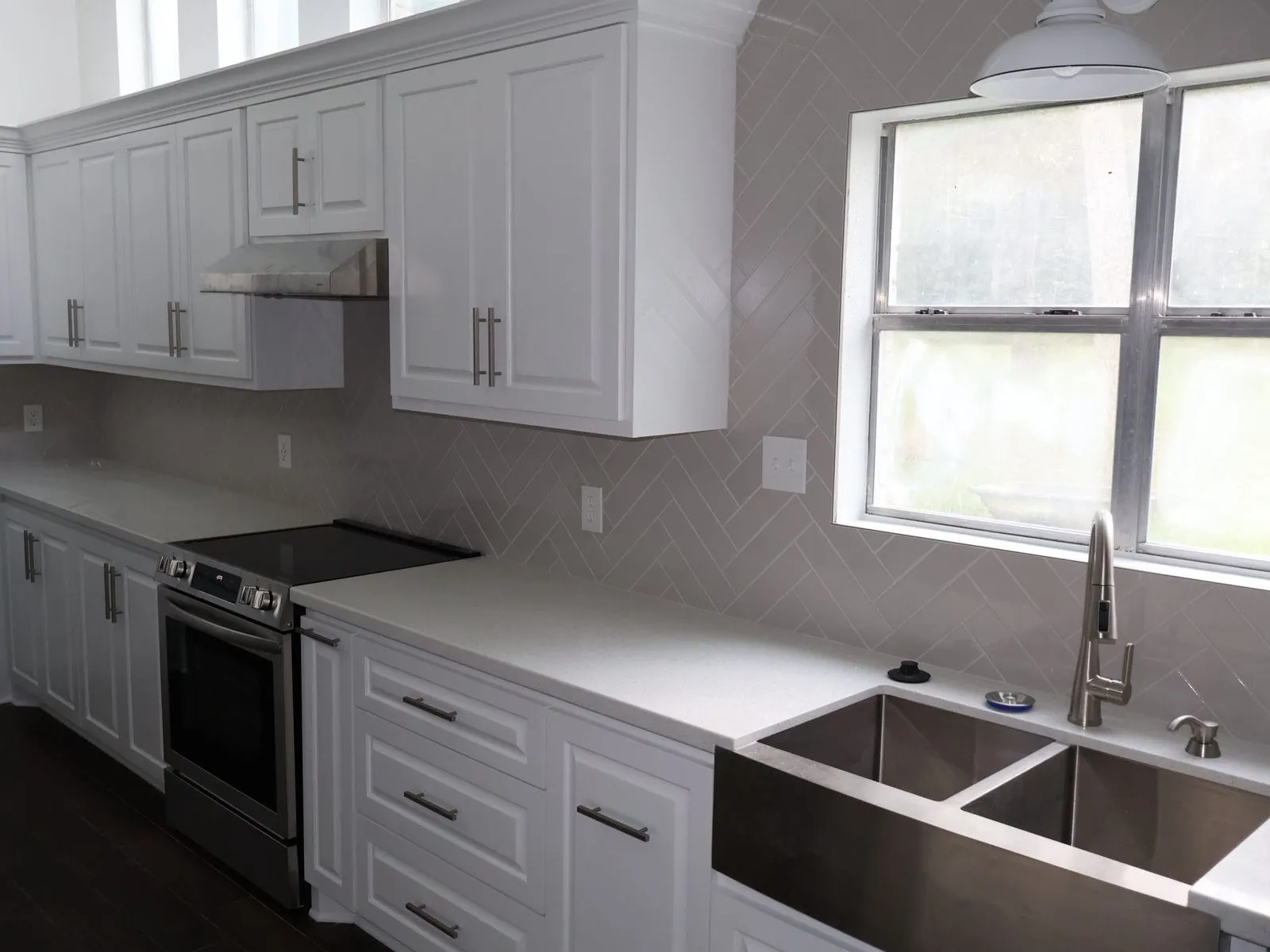 White shaker kitchen remodel with an apron-front sink in The Woodlands, TX