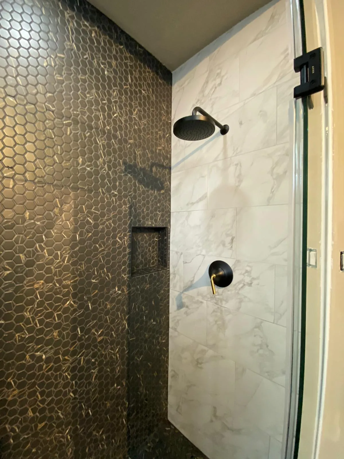 Bathroom remodel with a clawfoot tub, sage cabinetry, and gold penny-round shower tile in The Woodlands, TX