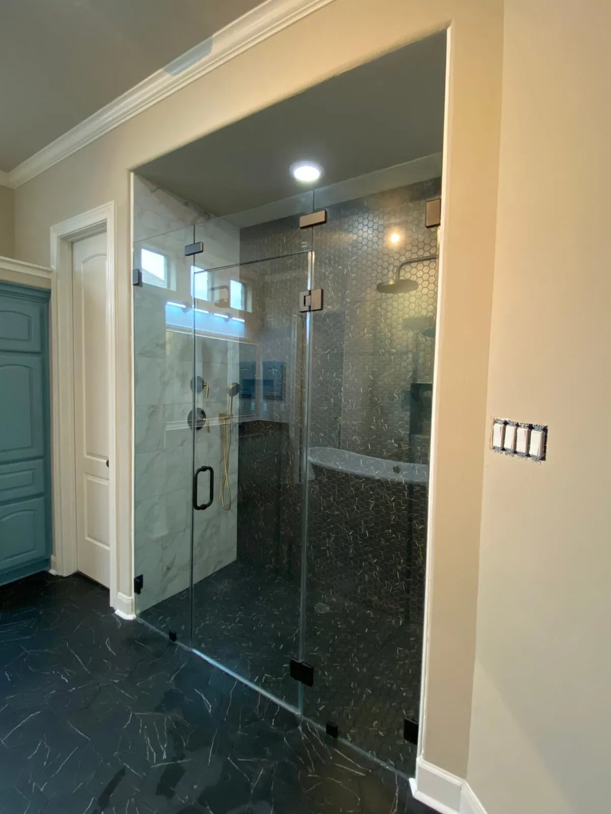 Bathroom remodel with a clawfoot tub, sage cabinetry, and gold penny-round shower tile in The Woodlands, TX