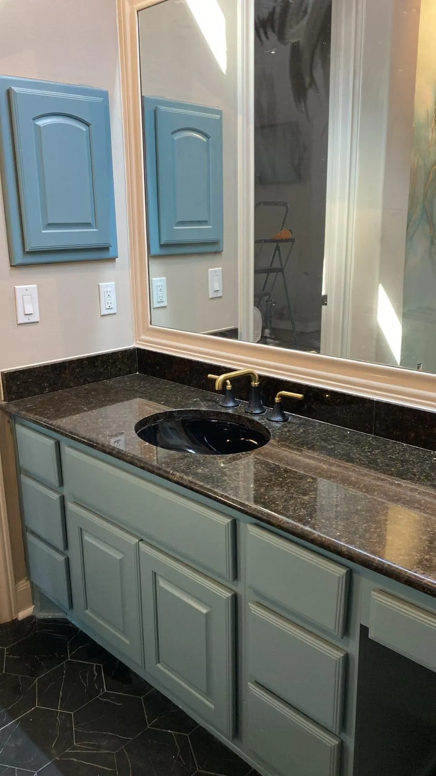 Painted vanity cabinetry with a granite top in a bathroom remodel in The Woodlands, TX