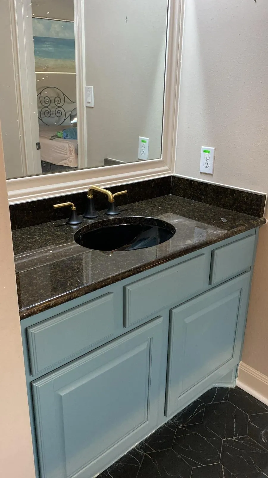 Bathroom remodel with a clawfoot tub, sage cabinetry, and gold penny-round shower tile in The Woodlands, TX