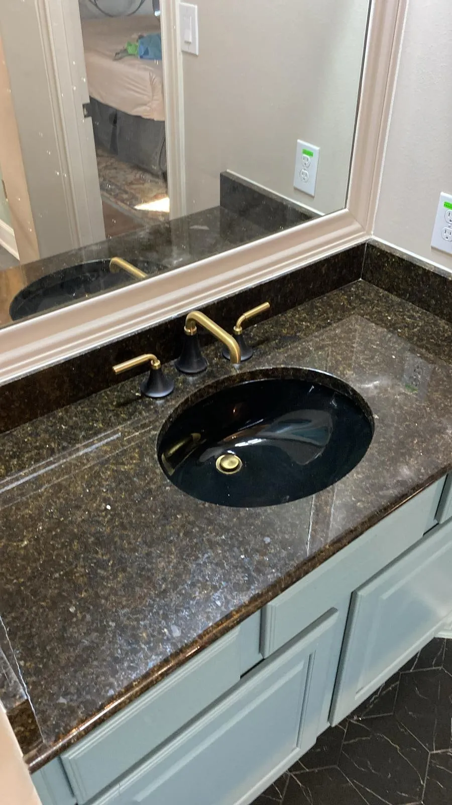 Bathroom remodel with a clawfoot tub, sage cabinetry, and gold penny-round shower tile in The Woodlands, TX