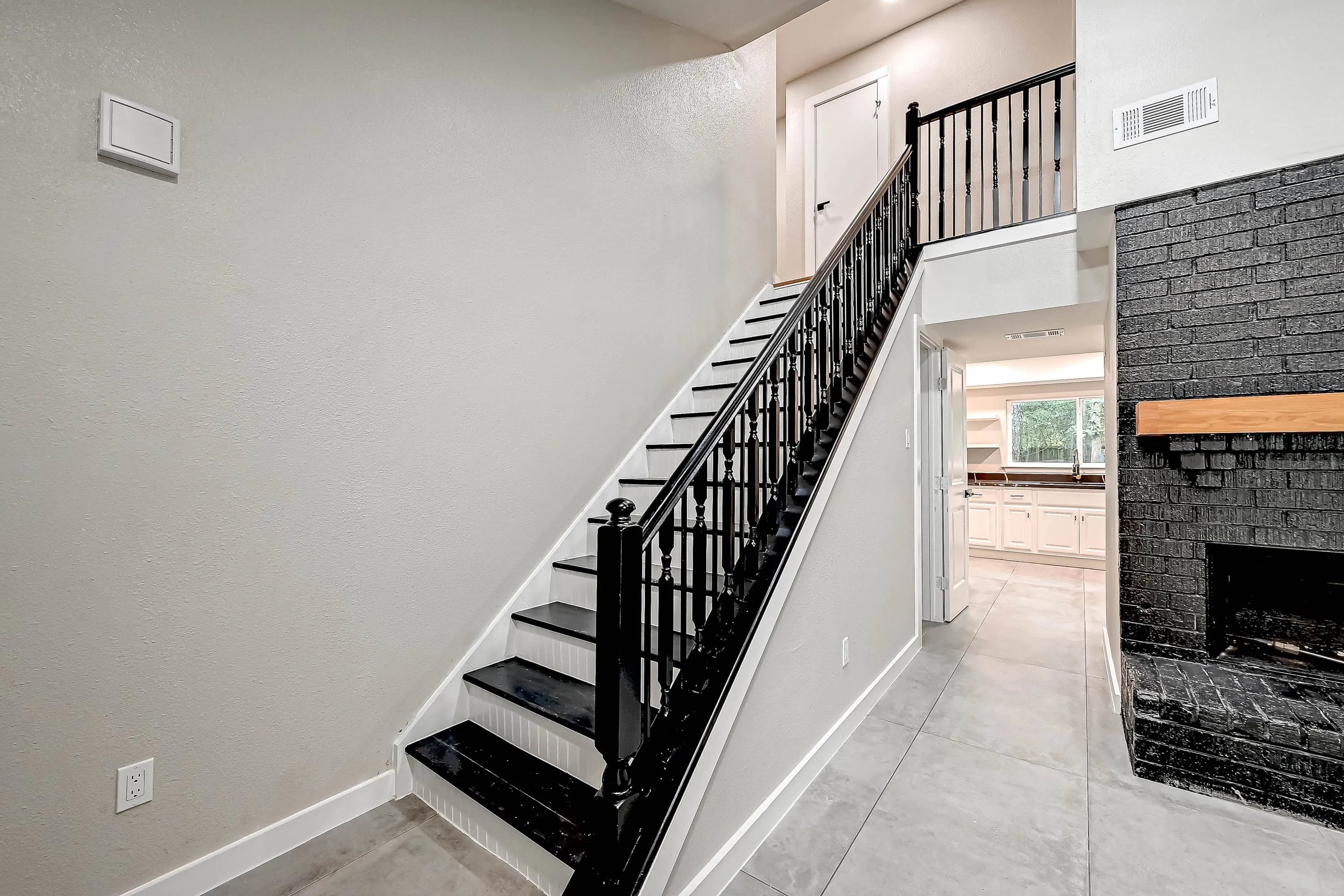 Whole home renovation of a mid-century house with a new kitchen and stair in The Woodlands, TX