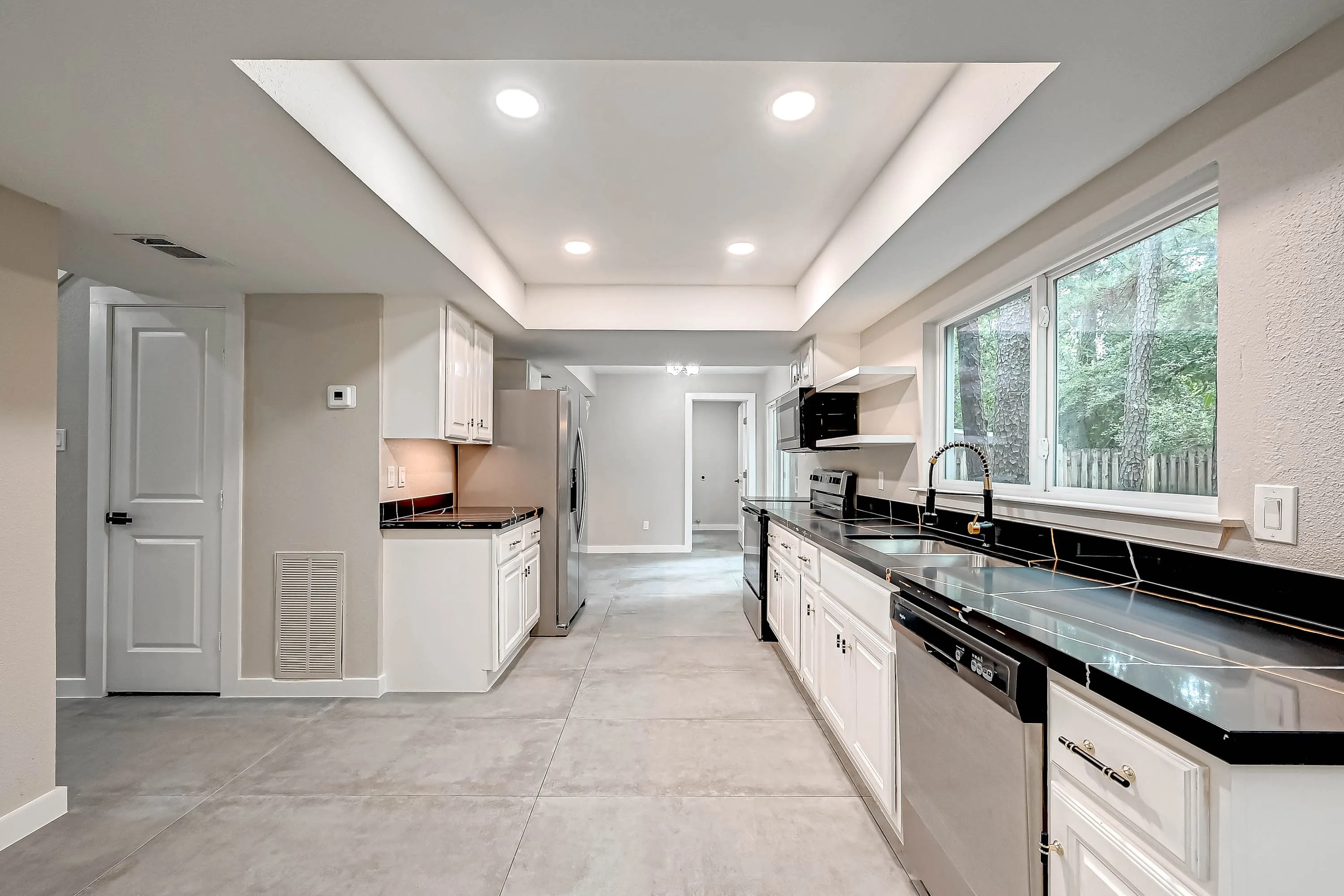 Whole home renovation of a mid-century house with a new kitchen and stair in The Woodlands, TX