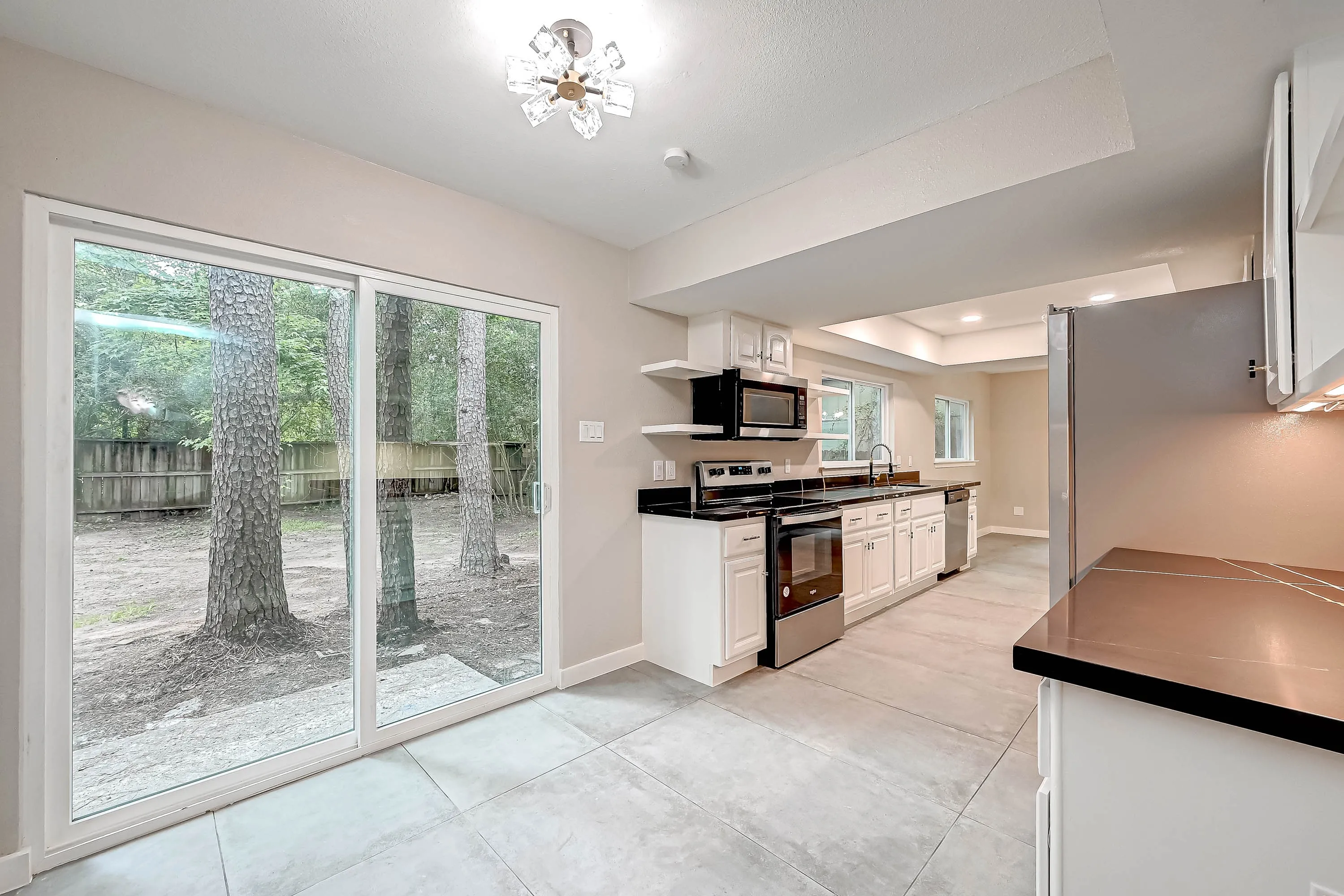 Whole home renovation of a mid-century house with a new kitchen and stair in The Woodlands, TX