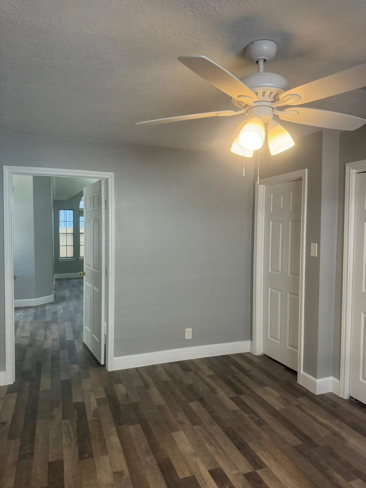 Whole home renovation with new plank flooring and arched windows in Panther Creek, The Woodlands, TX