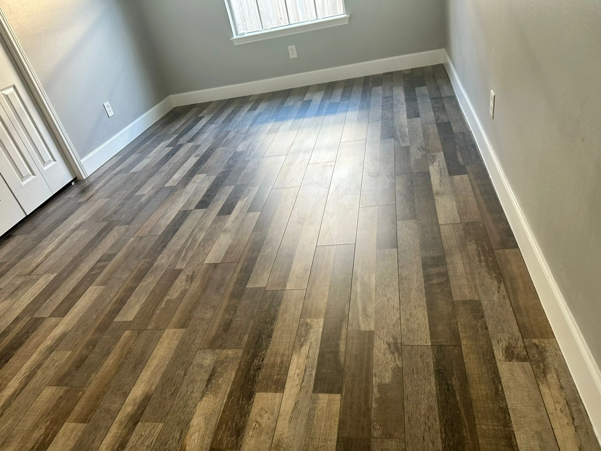 Whole home renovation with new plank flooring and arched windows in Panther Creek, The Woodlands, TX