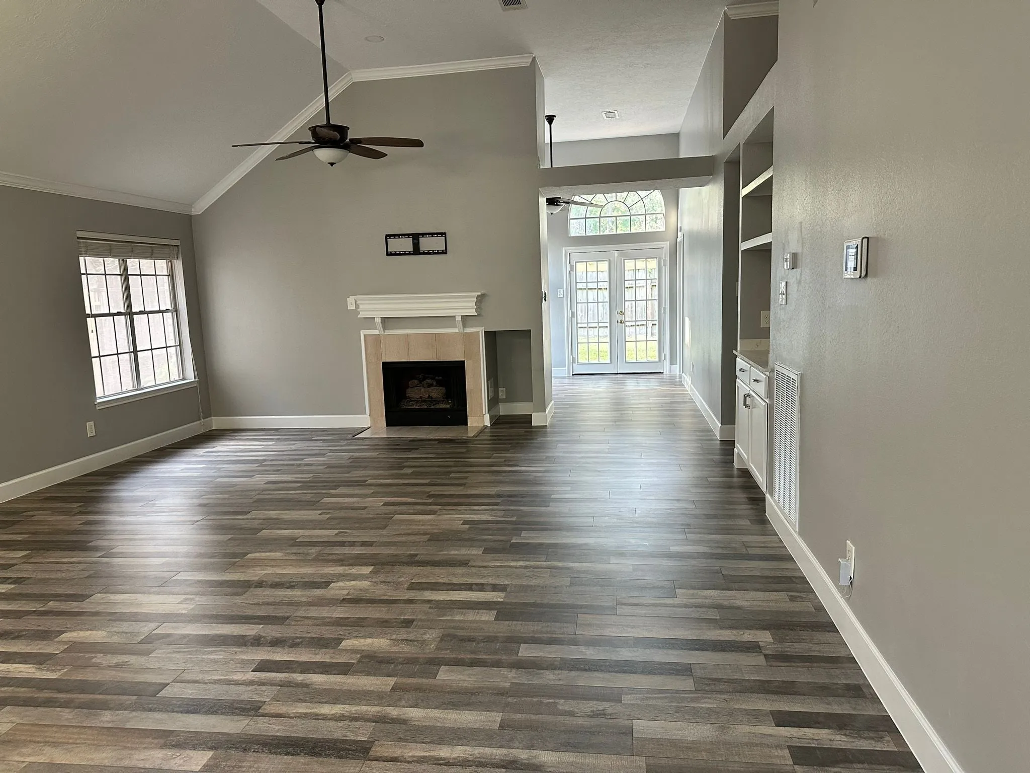 Whole home renovation with new plank flooring and arched windows in Panther Creek, The Woodlands, TX