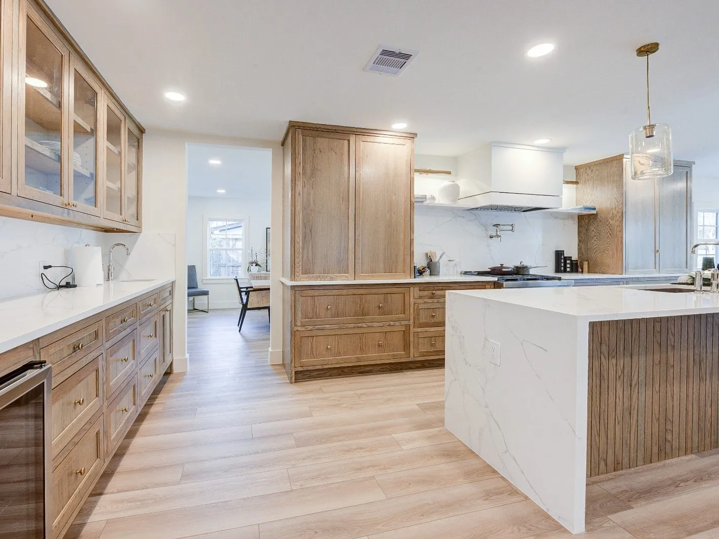Quartz waterfall island countertop with the vein carried through the mitre in The Woodlands, TX