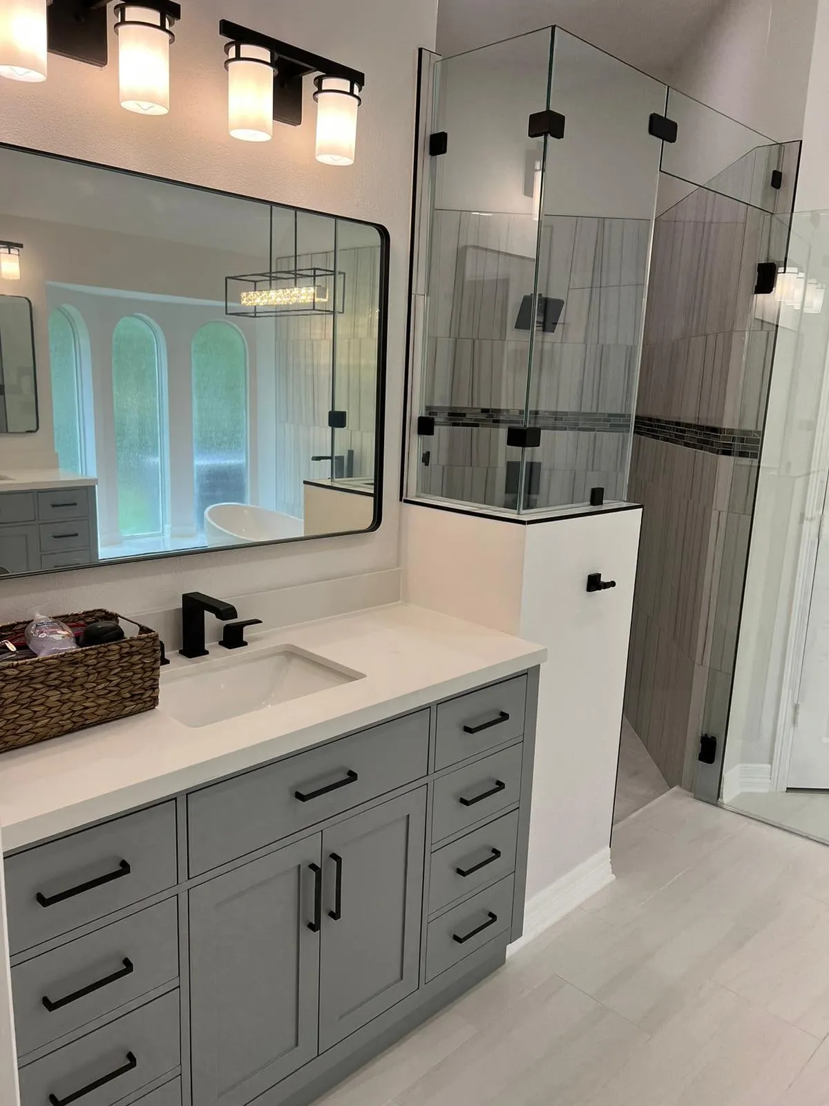Primary bathroom suite with a freestanding tub and a curbless stone wet room in Sterling Ridge, The Woodlands, TX