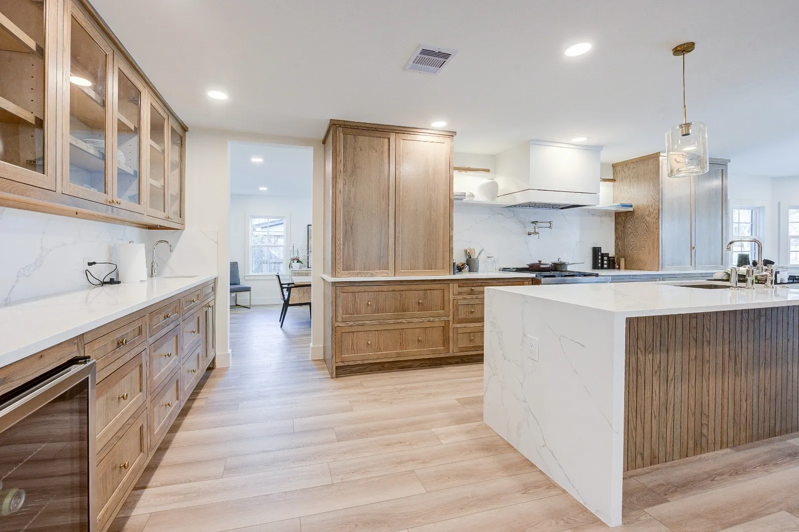 Wide plank engineered oak flooring running through a remodeled kitchen in The Woodlands, TX